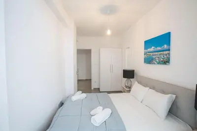 a bedroom with a large white bed with two pillows at Villa Olive Loux,Brand New, Exquisite 5Bdr Protaras Villa With Pool in Protaras