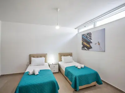 two beds in a room with a window at Villa Protaras Gold,Brand New, Luxury 5Bdr Protaras Villa With Private Pool in Protaras