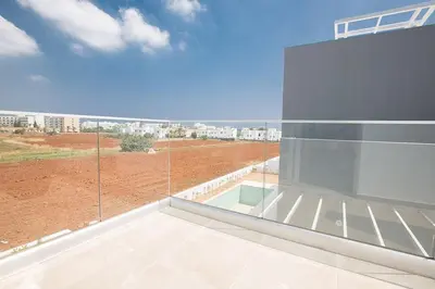 a balcony with a view of a building at Villa Manta Platina - Brand New Luxury 3 Bedroom Protaras Villa in Protaras