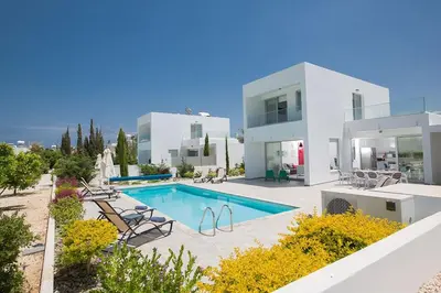 a large white house with a swimming pool at Villa Ochosto Helios - Beautiful 5 Bedroom Protaras Villa - Walking Distance in Protaras