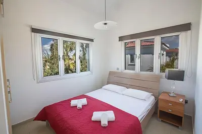 a bedroom with a bed with two towels on it at Villa Adaman - Stunning 3 Bedroom Seafront Villa With Pool - Close To The Beach in Ayia Napa