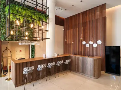 a restaurant with a bar with stools at Leonardo Boutique Hotel Larnaca in Larnaka