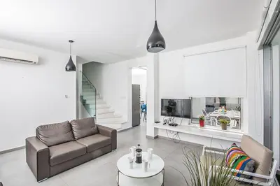 a living room with a couch and a table at Villa Ochosto Chrysos - Stunning 5 Bedroom Protaras Villa - Close To Fig Tree in Protaras