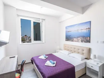 a white bedroom with a bed and a window at Villa Protaras Miramar, Luxury And New 5Bdr Protaras Villa With Pool in Protaras