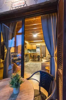 a room with a table and chairs and a living room at Cozy mountain apartment in Platres in Platres
