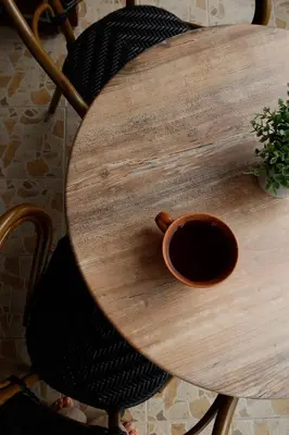 a wooden table with a cup of coffee on it at Cozy mountain apartment in Platres in Platres