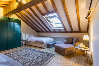 a attic bedroom with a bed and a couch at Cozy mountain apartment in Platres in Platres
