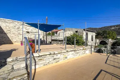 a basketball court in front of a stone building at Blue Oak House in Kato Drys
