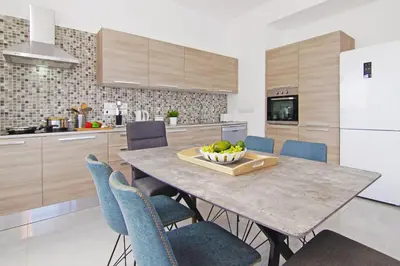 a kitchen with a table with a bowl of fruit on it at Villa Nova in Protaras