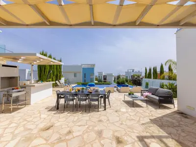 an outdoor patio with a table and chairs at Milos lifestyle villas H27 in Protaras