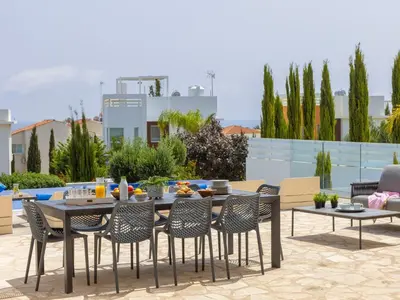 a patio with a table and chairs on a patio at Milos lifestyle villas H27 in Protaras