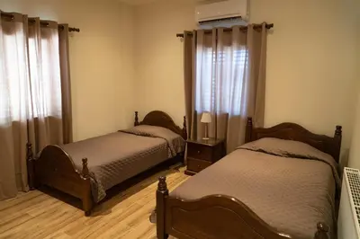 a bedroom with two beds and a window at Zangoulos Mountain in Kakopetria