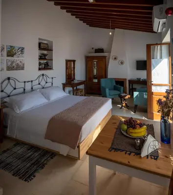 a bedroom with a bed and a table with a bowl of fruit at Rothkia's Home in Parekklisha