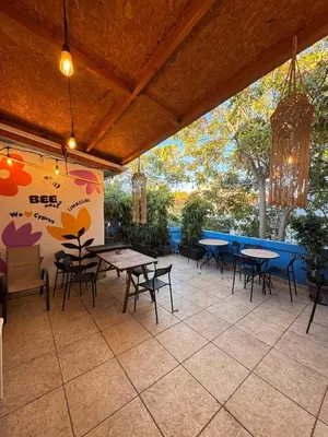 a patio with tables and chairs in a restaurant at Bee Hostel in Limassol