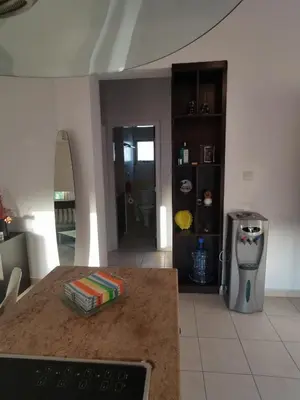 a kitchen with a table with books on it at Garden Luxury Apartment Ayia Napa in Ayia Napa