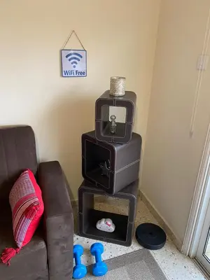a living room with a tv and a couch at Larnaca Comfort Rooms With Smart TV & Netflix in Larnaka