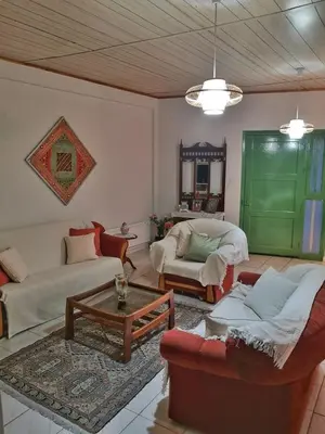 a living room with two couches and a table at Moutoullas Mountain Views in Moutoullas