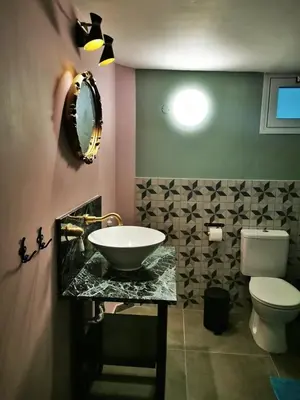 a bathroom with a sink and a toilet at Moutoullas Mountain Views in Moutoullas
