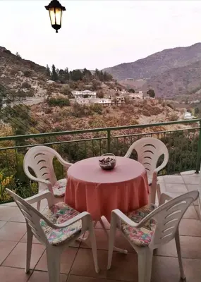 a table and chairs on a balcony with a view at Moutoullas Mountain Views in Moutoullas