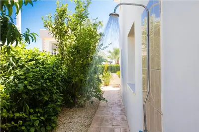 a garden with a pathway leading into a house at Carilisto Villas Big 4 Bedrooms in Center of Ayia Napa in Ayia Napa