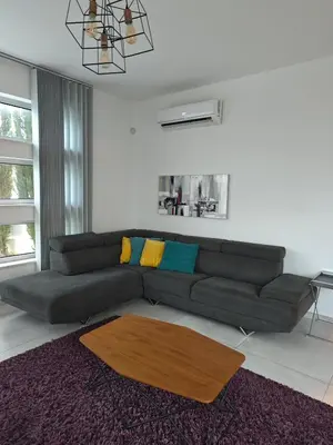 a living room with a couch and a table at Maximos Luxury Villa Monagri Limassol in Limassol