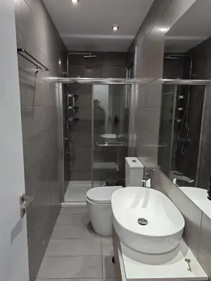 a bathroom with a toilet and a sink and a shower at Maximos Luxury Villa Monagri Limassol in Limassol