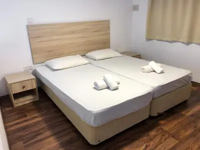 a bedroom with a bed with two towels on it at Cozy Loft Apartment 2 in Ayia Napa