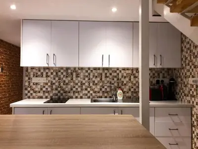 a kitchen with white cabinets and a counter top at Cozy Loft Apartment 2 in Ayia Napa