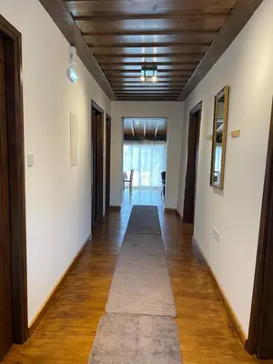 a hallway with white walls and a wooden ceiling at Omodos Katoi Holiday Homes in Omodos