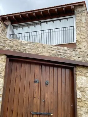 a wooden garage door with a window on top at Omodos Katoi Holiday Homes in Omodos