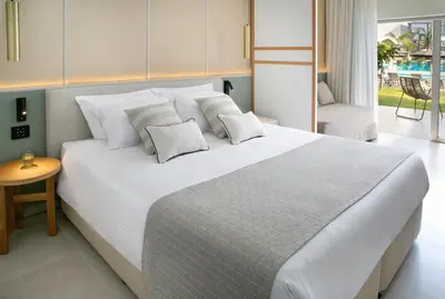a bedroom with a large white bed with pillows at Atlantica Aqua Blue in Protaras