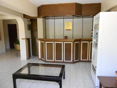 a room with a table and some cabinets at Denis Hotel in Nicosia