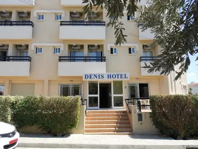a building with a sign that reads drinks hotel at Denis Hotel in Nicosia