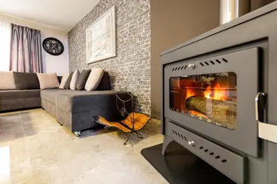 a living room with a fireplace and a couch at Pinecone Platres - 3 Units in Platres