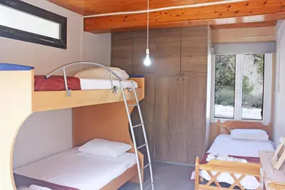 two bunk beds in a small room with a ladder at Laoni Guest House in Moutoullas, Marathasa in Limassol