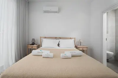 a bedroom with a bed with two pillows on it at Periyiali Konnos Villas Beach Resort in Protaras