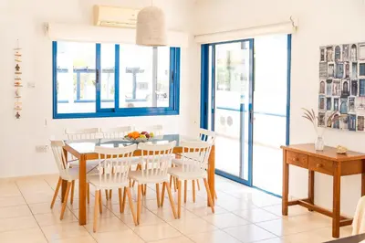 a dining room with a table and chairs at St Nicolaos Villa Ekaterina 3 bdrm in Protaras