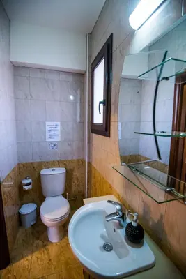 a bathroom with a toilet and a sink and a mirror at Luxury Villa Regina in Protaras
