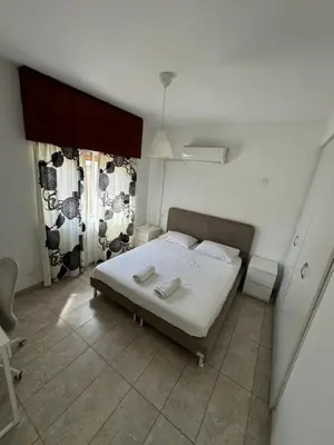 a bedroom with a bed with two towels on it at Milky in Limassol