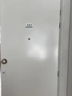 a sign on the door of a white refrigerator at Milky in Limassol