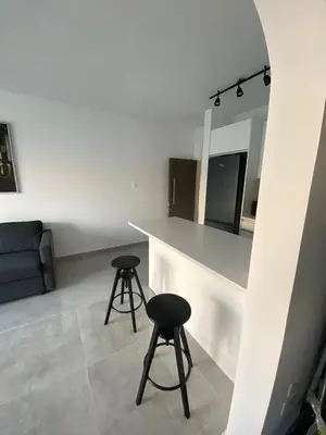 a kitchen with two stools and a counter in a room at Greco 1 Bedroom Apartment in Limassol