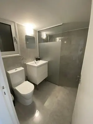 a bathroom with a toilet and a sink and a shower at Greco 1 Bedroom Apartment in Limassol