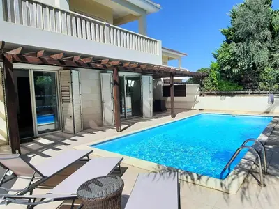 a swimming pool in the backyard of a house at Villa Larnaca Bay Resort in Voroklini