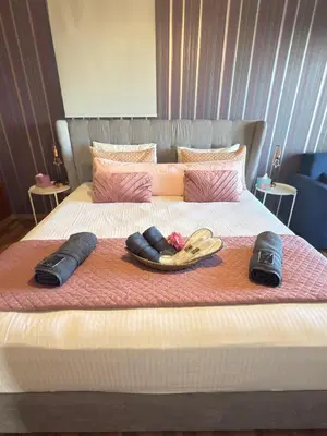 a bed with two hats and flip flops on it at Kasparis View Residence in Pano Lefkara