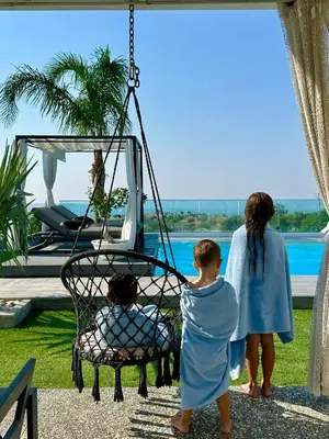 two girls and a boy looking at a swing at Kasparis View Residence in Pano Lefkara