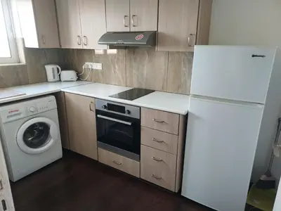 a kitchen with a white refrigerator and a washing machine at Magic Sea Apartments in Larnaka