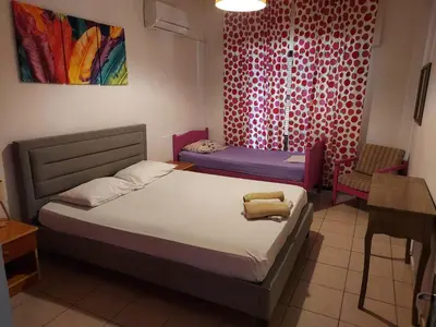 a bedroom with a bed and a table and a chair at Magic Sea Apartments in Larnaka