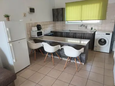 a kitchen with a counter and white appliances at Magic Sea Apartments in Larnaka