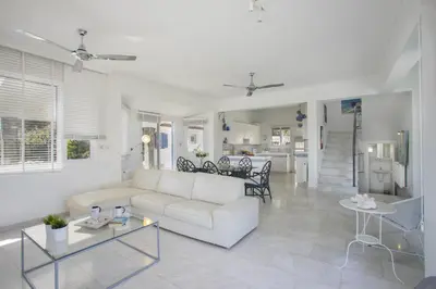 a living room with a white couch and a table at Protaras Villa Mazeri in Protaras