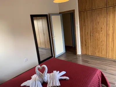 a room with a bed with a towel shaped like a heart at Kika Court 2 in Paralimni
